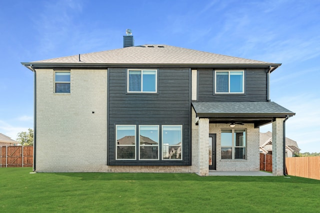 back of property with a patio, a yard, and ceiling fan