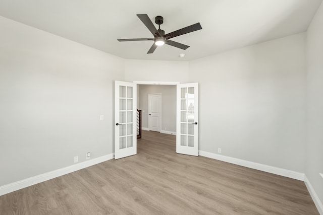 empty room featuring ceiling fan, light hardwood / wood-style flooring, and french doors