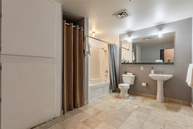 bathroom with shower / bath combination with curtain and toilet