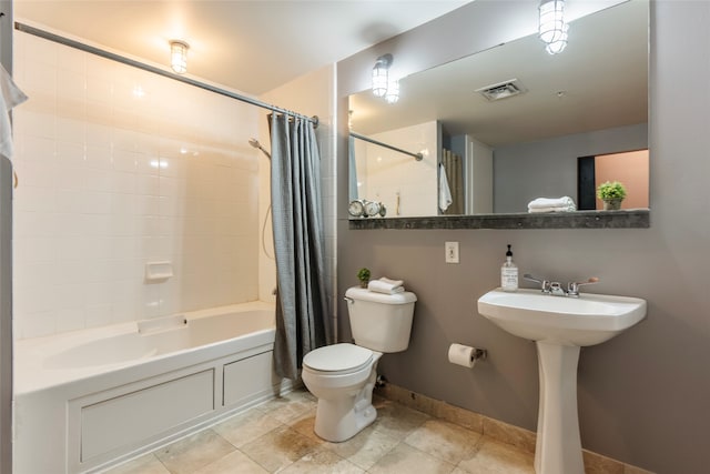 full bathroom with sink, shower / bathtub combination with curtain, and toilet