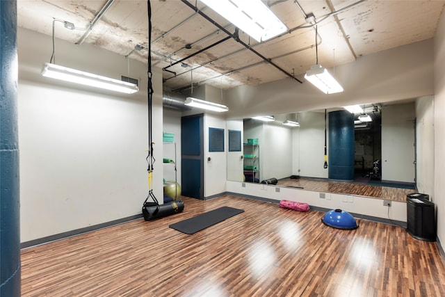 workout area with wood-type flooring