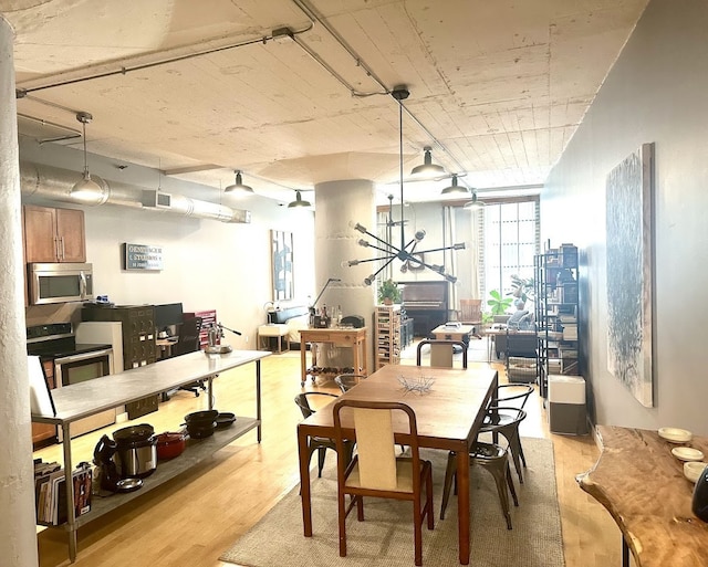 dining space with light wood-type flooring