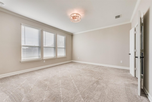 spare room with carpet floors, crown molding, and a wealth of natural light