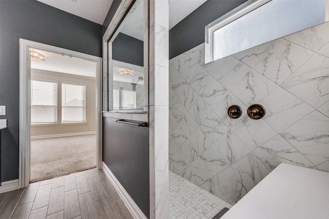 bathroom with plenty of natural light and tiled shower