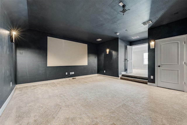 carpeted home theater featuring a textured ceiling