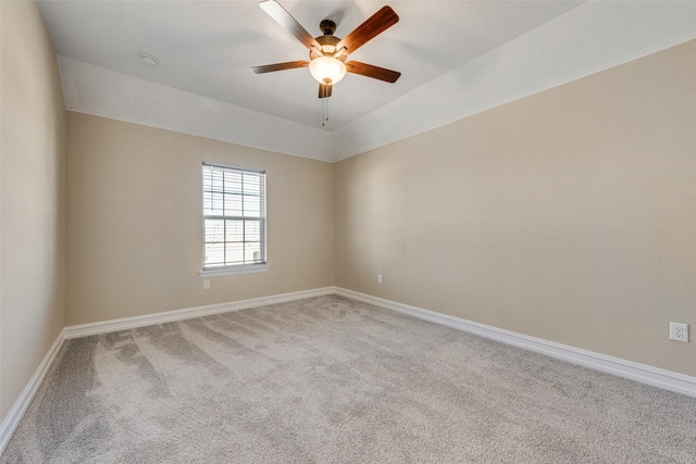 spare room with vaulted ceiling, carpet floors, and ceiling fan