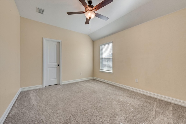 carpeted empty room featuring ceiling fan and lofted ceiling