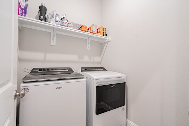 clothes washing area featuring washer and dryer