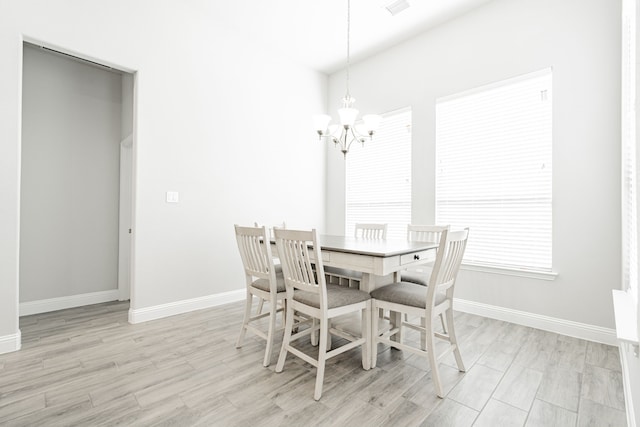 dining room with a chandelier and light hardwood / wood-style floors