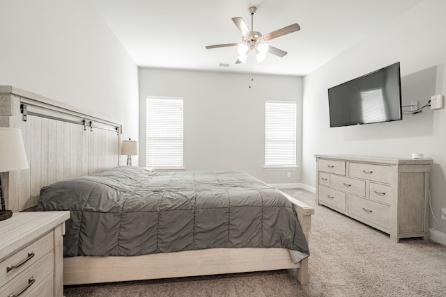 bedroom with ceiling fan and light colored carpet