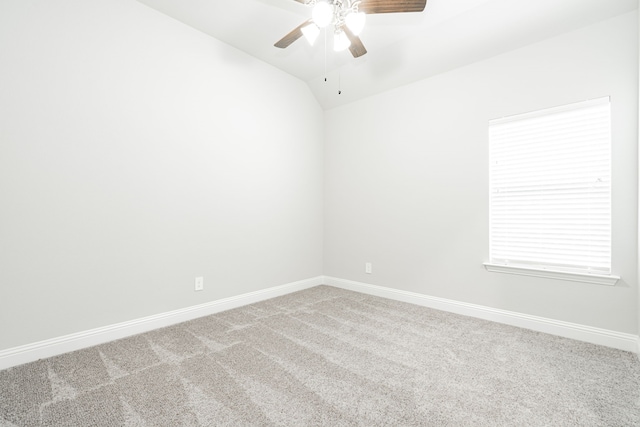 empty room featuring carpet flooring, ceiling fan, and vaulted ceiling