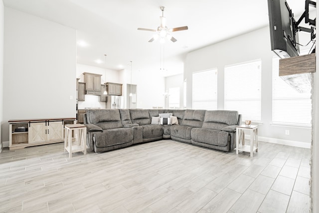 living room featuring light hardwood / wood-style flooring and ceiling fan