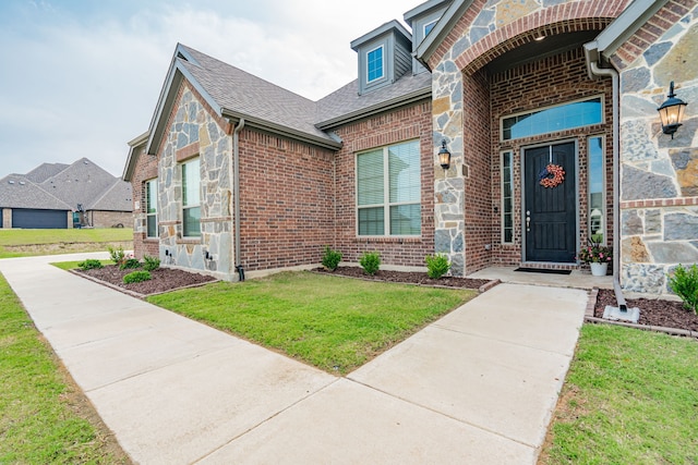 property entrance with a yard