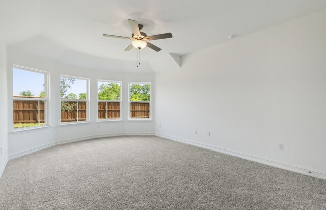 carpeted empty room with vaulted ceiling and ceiling fan