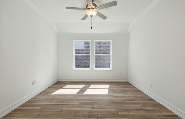 empty room with ceiling fan, light hardwood / wood-style floors, and lofted ceiling