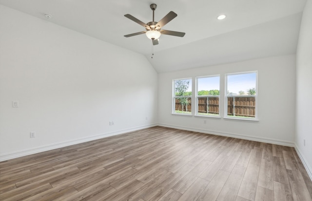 unfurnished room featuring ceiling fan, light hardwood / wood-style floors, and vaulted ceiling