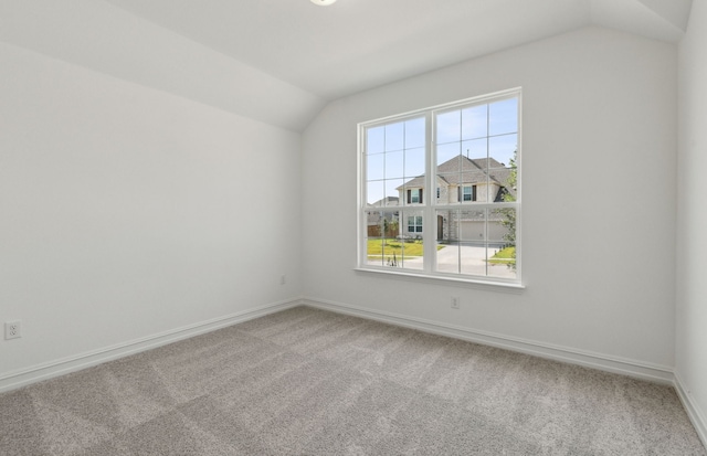 unfurnished room with carpet and lofted ceiling