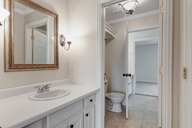 bathroom with tile patterned floors, vanity, ornamental molding, and toilet