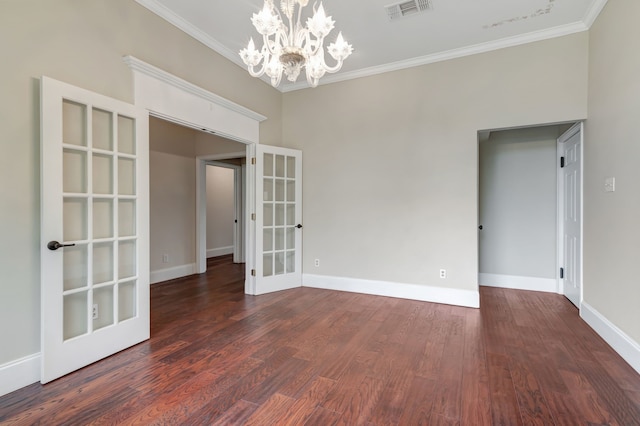 unfurnished room with crown molding, french doors, dark hardwood / wood-style floors, and an inviting chandelier