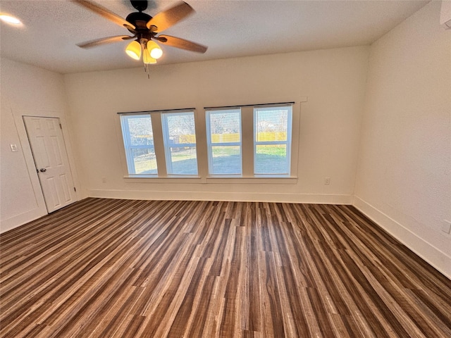 unfurnished room with ceiling fan, a textured ceiling, baseboards, and wood finished floors