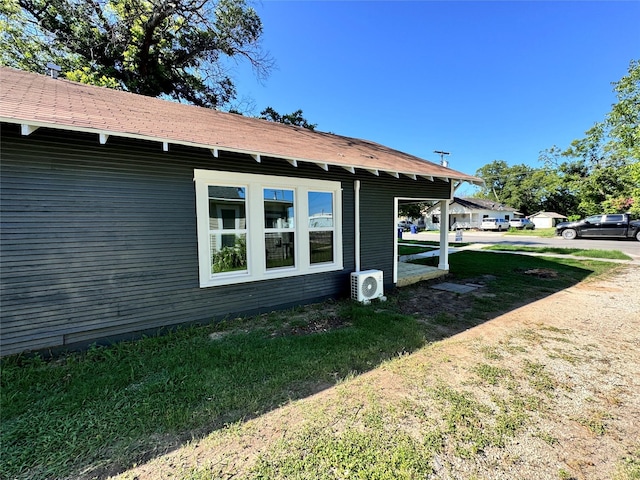 view of property exterior featuring ac unit and a lawn