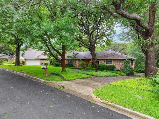 ranch-style house featuring a front yard and a garage