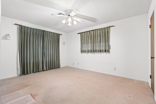 carpeted empty room featuring a textured ceiling and ceiling fan