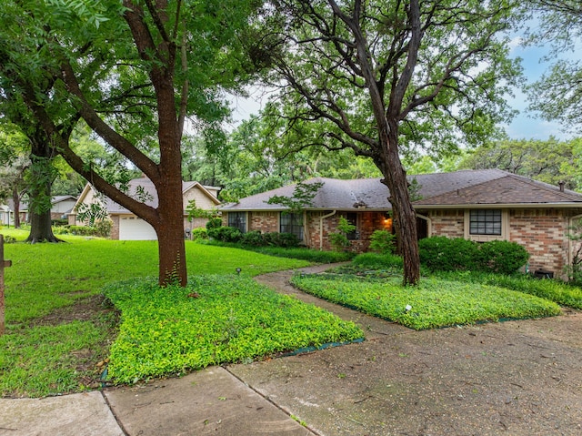 ranch-style house featuring a front yard and a garage