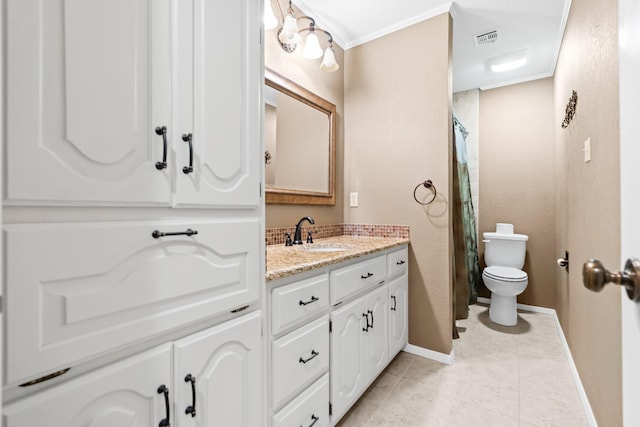 bathroom with tile patterned floors, toilet, vanity, and ornamental molding