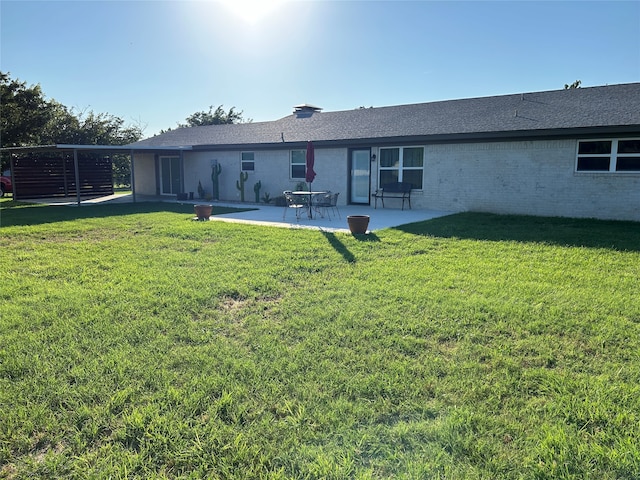 rear view of house with a patio area and a lawn