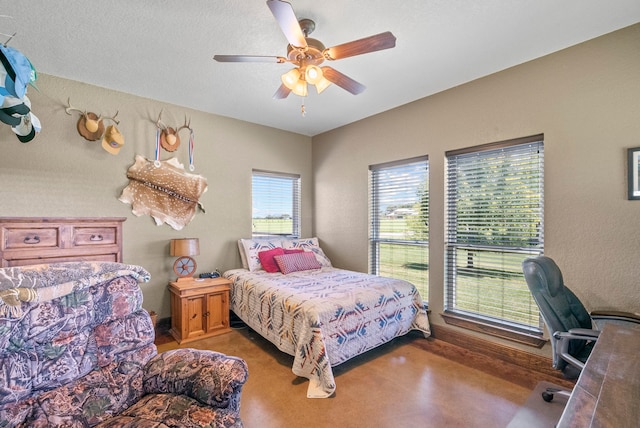 bedroom featuring ceiling fan and multiple windows