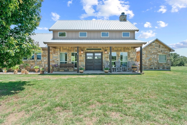 rear view of property with a porch and a lawn