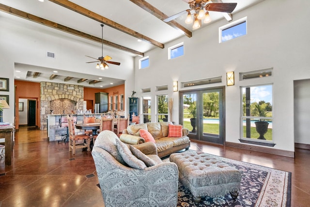 living room featuring a towering ceiling, ceiling fan, french doors, and a fireplace