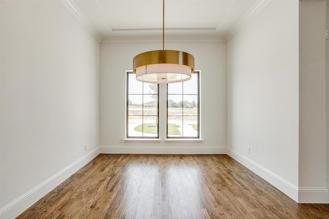 unfurnished dining area with crown molding, baseboards, and wood finished floors