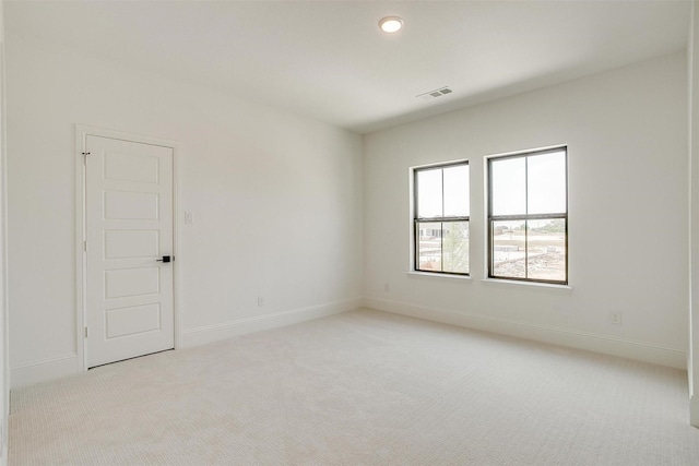 unfurnished room featuring light carpet, visible vents, recessed lighting, and baseboards