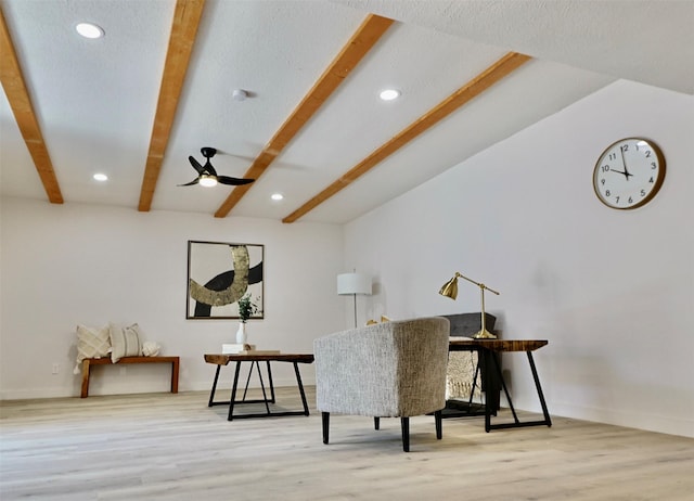 sitting room with vaulted ceiling with beams, light hardwood / wood-style flooring, and ceiling fan