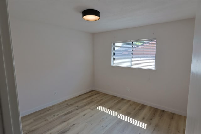 spare room with light hardwood / wood-style flooring