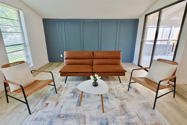 living room featuring vaulted ceiling and light hardwood / wood-style flooring