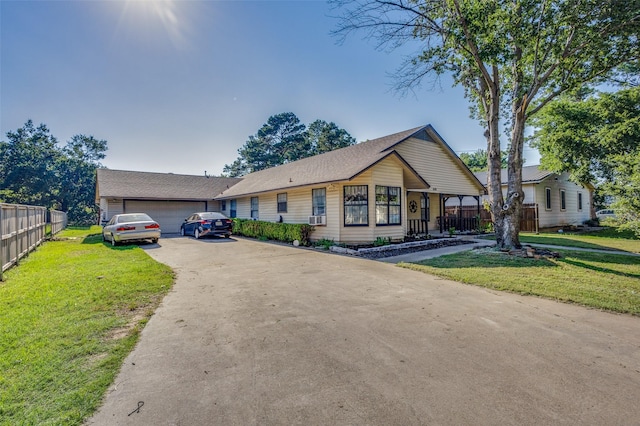 view of front of house featuring a front yard, a garage, and cooling unit