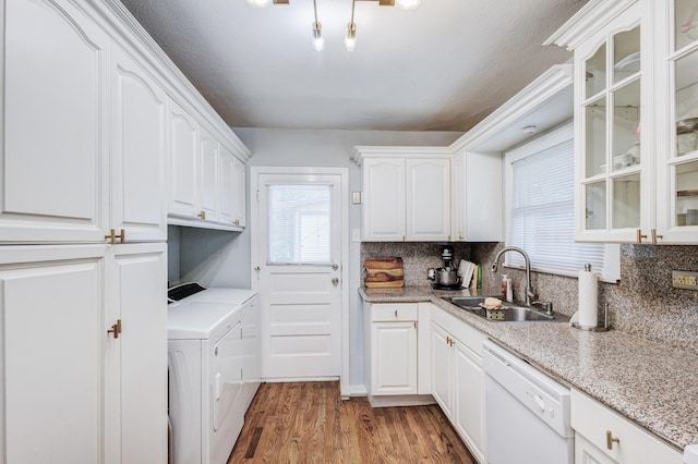 kitchen featuring dishwasher, white cabinets, sink, separate washer and dryer, and dark hardwood / wood-style flooring