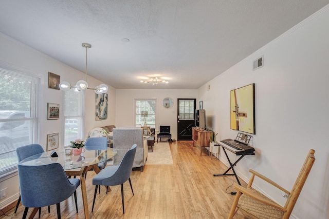 dining room featuring crown molding and light wood-type flooring