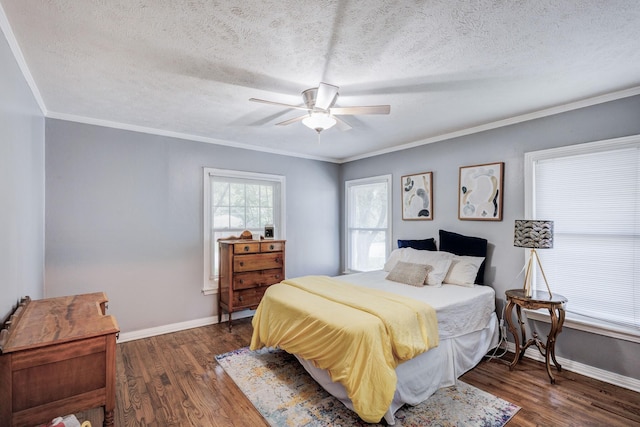 bedroom with a textured ceiling, dark hardwood / wood-style flooring, ceiling fan, and ornamental molding