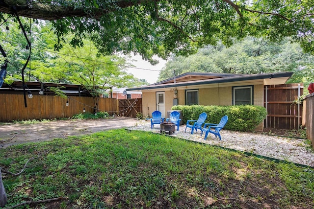 rear view of house featuring a fire pit