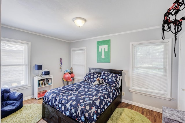 bedroom featuring hardwood / wood-style floors and ornamental molding