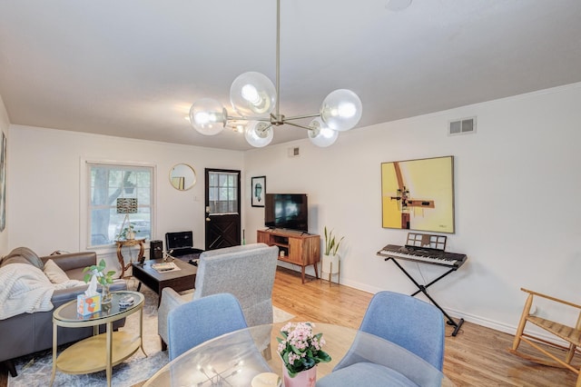 living room with light hardwood / wood-style floors and ornamental molding