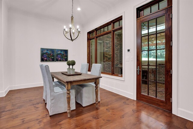 dining room featuring dark wood-type flooring and an inviting chandelier