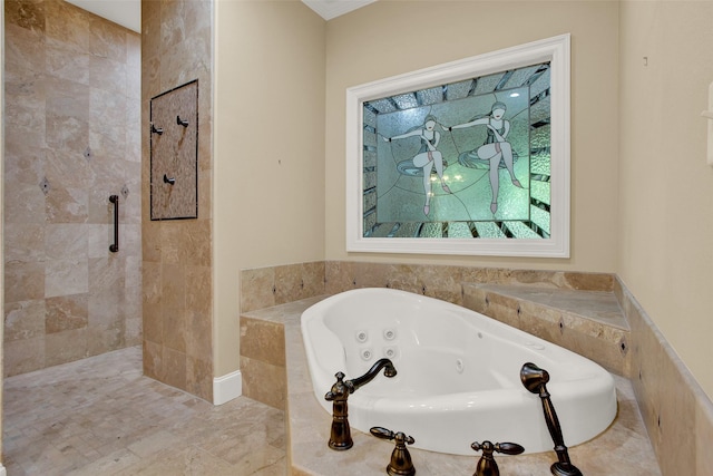 bathroom with a tub with jets and tiled shower