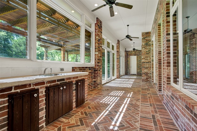 view of patio with ceiling fan and sink