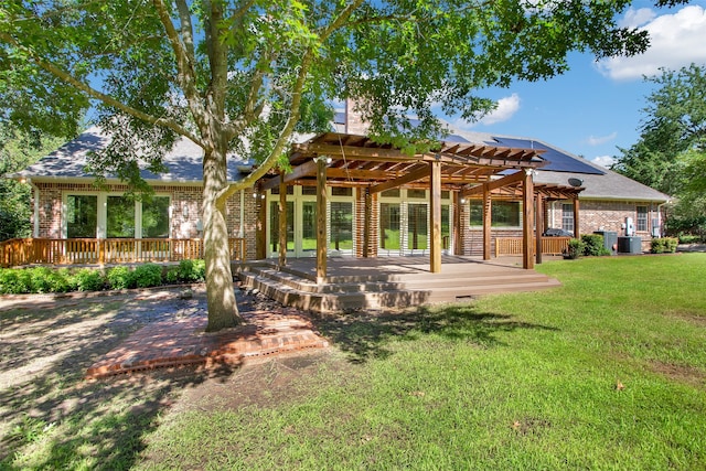 back of property featuring a yard, a pergola, and a patio area