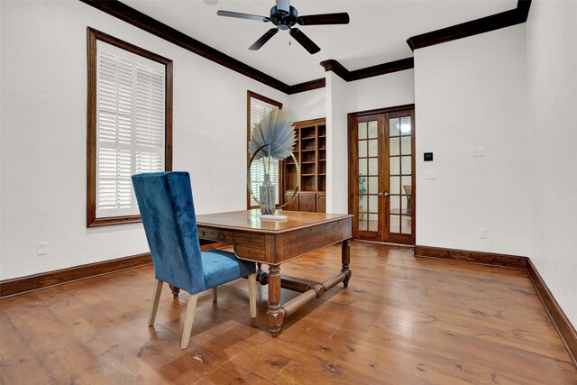 dining area featuring hardwood / wood-style floors, plenty of natural light, ornamental molding, and french doors